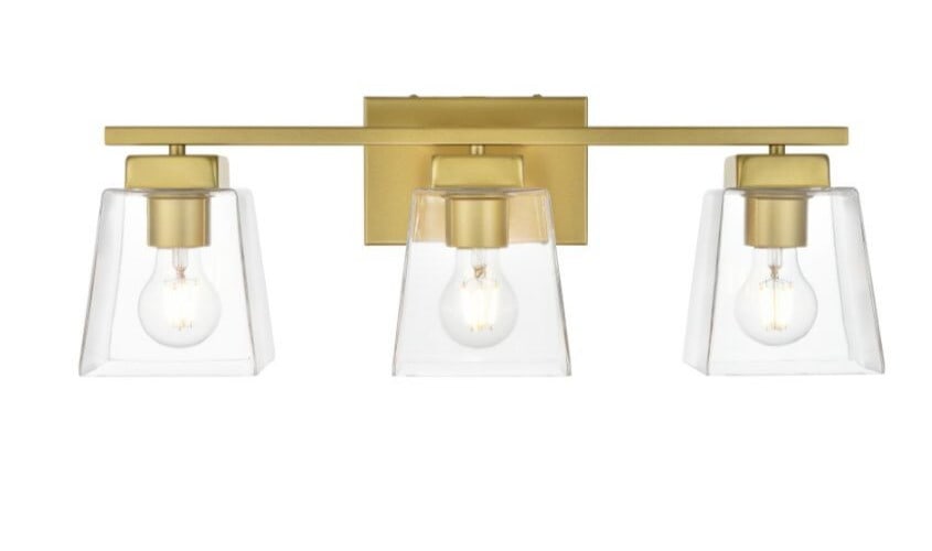 Merrick Brass 3 Light Glass Shade Wall Sconce 22.9 in: Merrick Brass 3 Light Glass Shade Wall Sconce 22.9 in This modern brass wall sconce features three lights with clear glass dome shades, offering both upward and downward illumination. Designed for ind