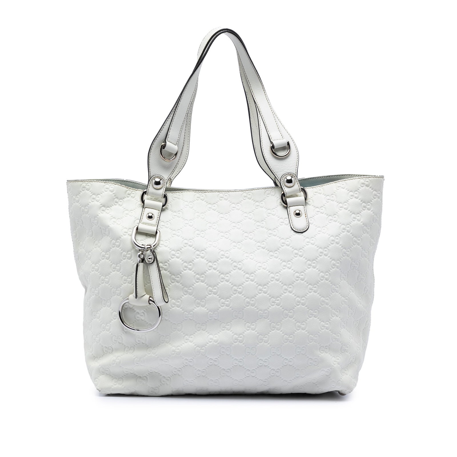 White Gucci Leather Medium Guccissima Icon Bit Tote: White Gucci Leather Medium Guccissima Icon Bit Tote This tote bag features an embossed leather body with flat leather handles, an open top secured by a magnetic snap closure, and interior zip and slip