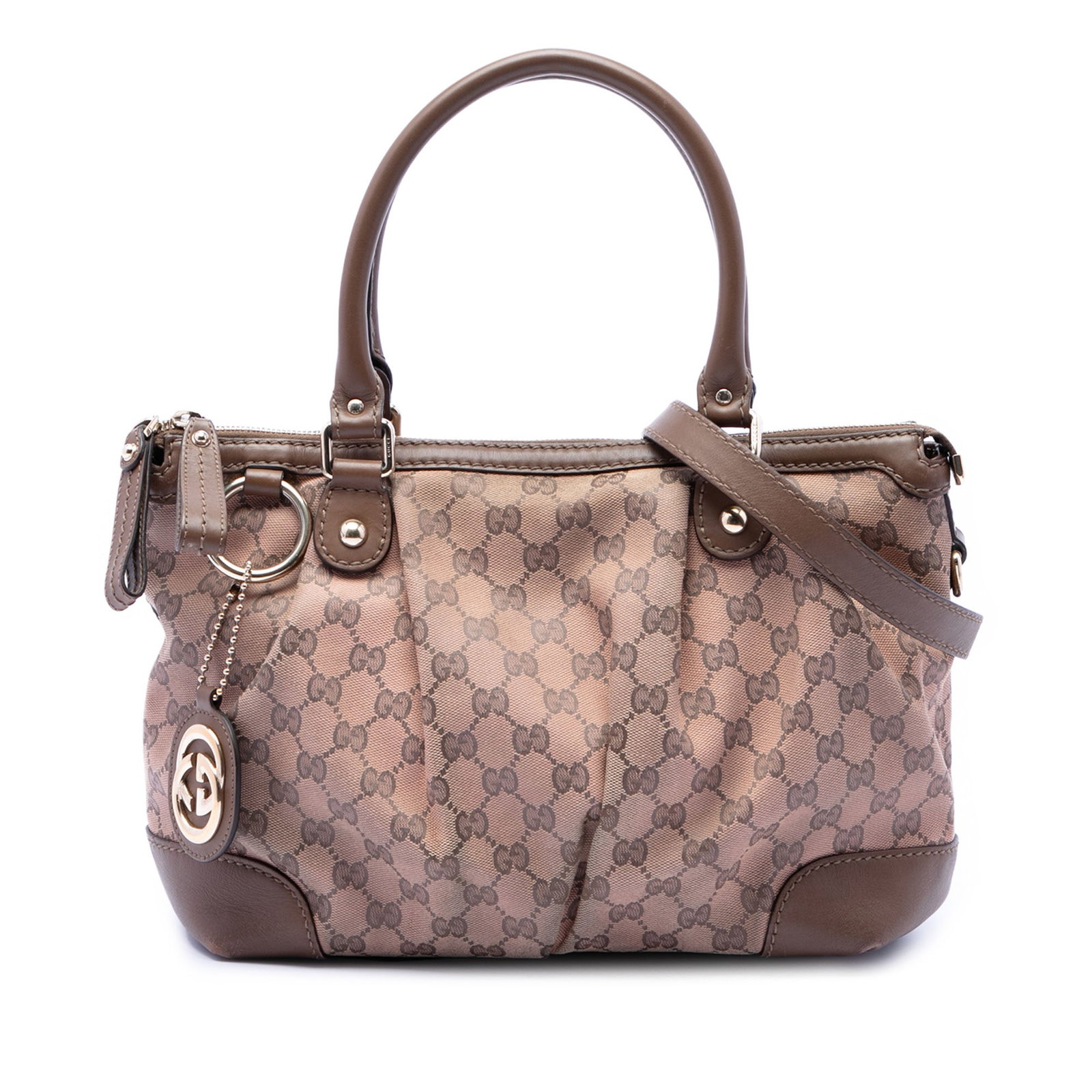 Gucci Sukey Beige GG Canvas Satchel: Gucci Sukey Beige GG Canvas Satchel This Gucci GG Canvas Sukey Satchel features a beige canvas body with leather trim, rolled leather handles, a detachable flat strap, and a top zip closure. The inter