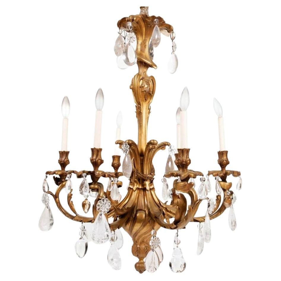 Six-Light Gilt Bronze Chandelier with Rock Crystal Accents Louis XV Style: Six-Light Gilt Bronze Chandelier with Rock Crystal Accents Louis XV Style This Louis XV style chandelier features a gilt bronze frame adorned with rock crystals. Designed with six lights, it showcases