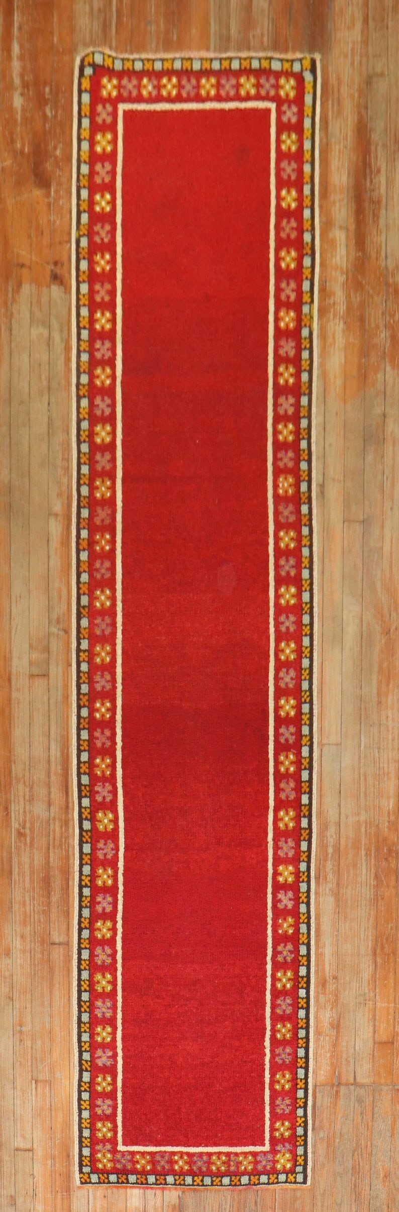 2'5" x 10'11" Turkish Wool Tulu Runner in Bright Red Minimalist Design: 2'5" x 10'11" Turkish Wool Tulu Runner in Bright Red Minimalist Design This bright red vintage Turkish Tulu runner from the mid-20th century features a minimalist design with a plain open field and a 