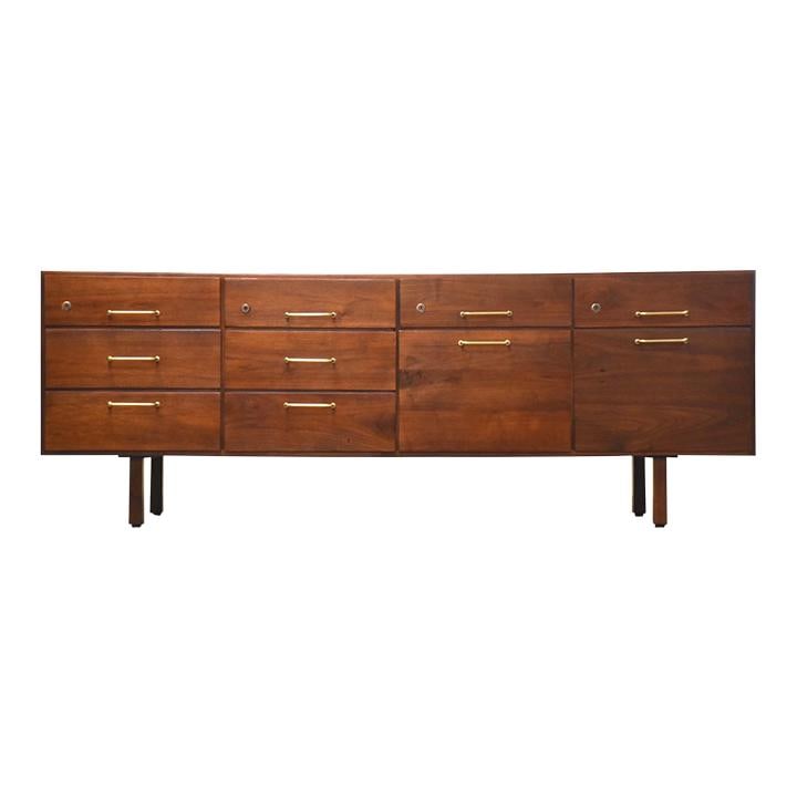 Jens Risom Mid-Century Walnut Credenza with Brass Pulls: Jens Risom Mid-Century Walnut Credenza with Brass Pulls This stunning mid-century modern credenza, designed by Jens Risom, showcases a beautiful walnut finish complemented by elegant brass drawer pull