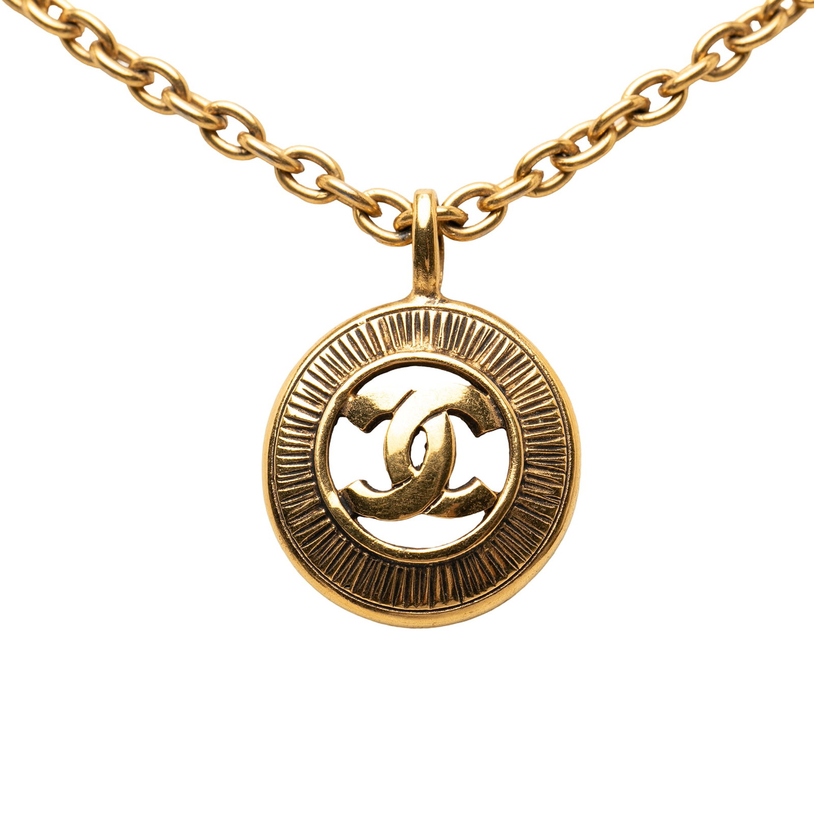 Chanel CC Medallion Pendant Necklace Gold Plated Sunburst: Chanel CC Medallion Pendant Necklace Gold Plated Sunburst This Chanel necklace showcases a gold-tone metal construction with a distinctive sunburst medallion pendant and a spring ring closure. The pie