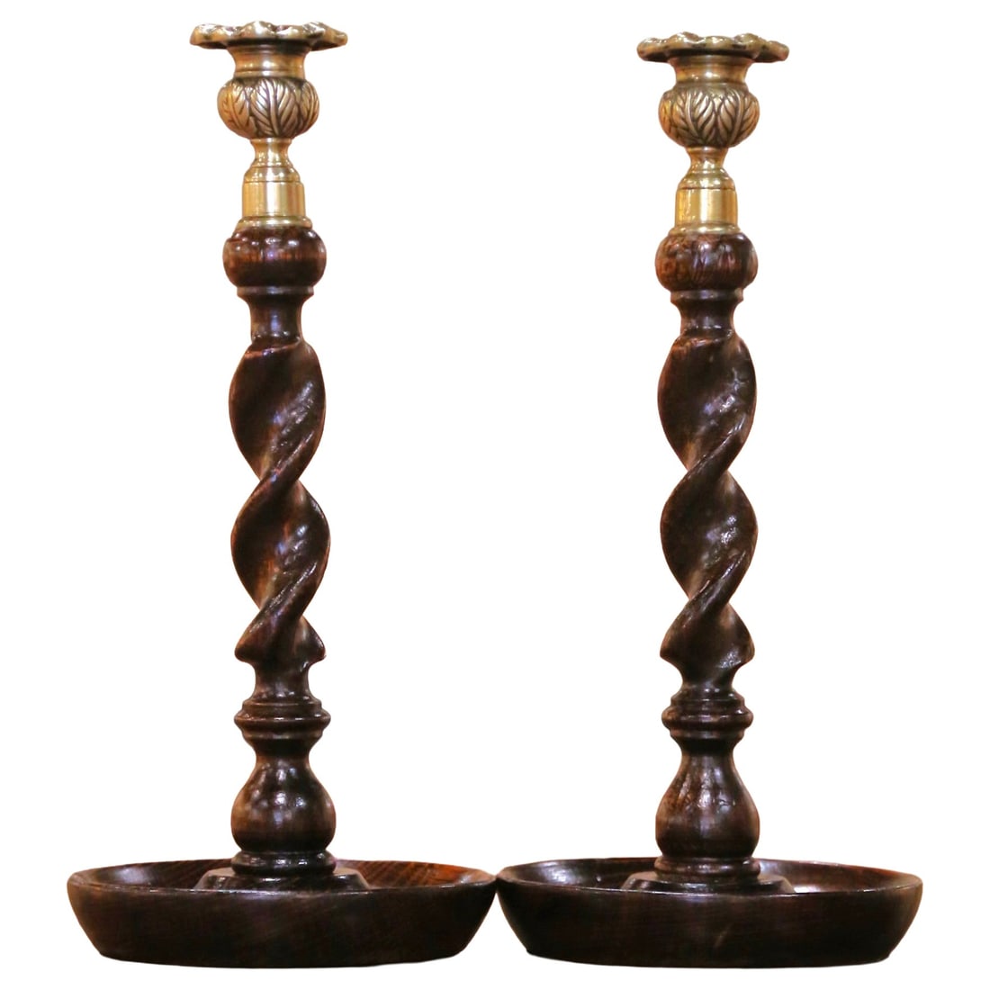 English Oak Candlestick Pair with Brass Cups Barley Twist circa 1920: English Oak Candlestick Pair with Brass Cups Barley Twist circa 1920 Pair of early 20th century English candlesticks in the Victorian style, made of oak and brass. Each candlestick features a hand-tur