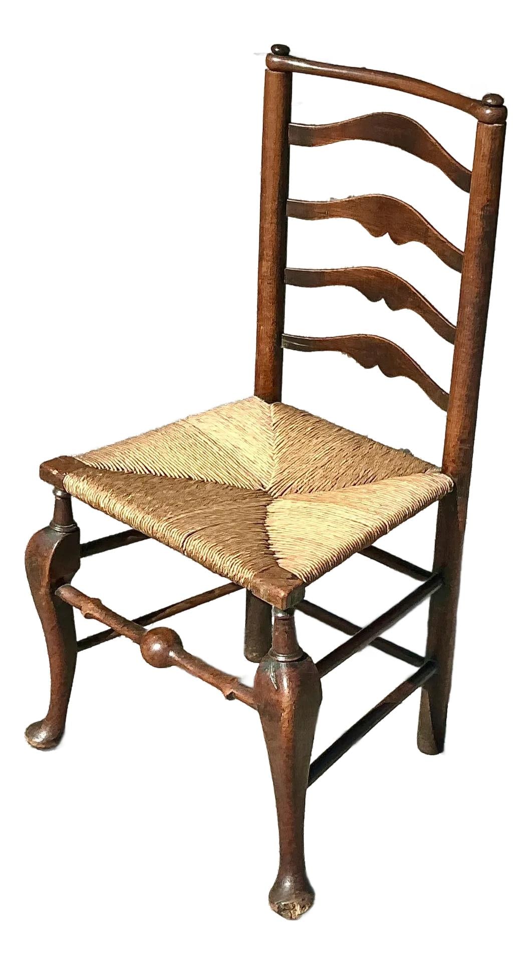 19th Century Vintage Ladderback Chair with Rush Seat: 19th Century Vintage Ladderback Chair with Rush Seat This exquisite 19th-century ladderback chair showcases rustic charm with its elegantly curved wooden frame and woven rush seat. Crafted with classi