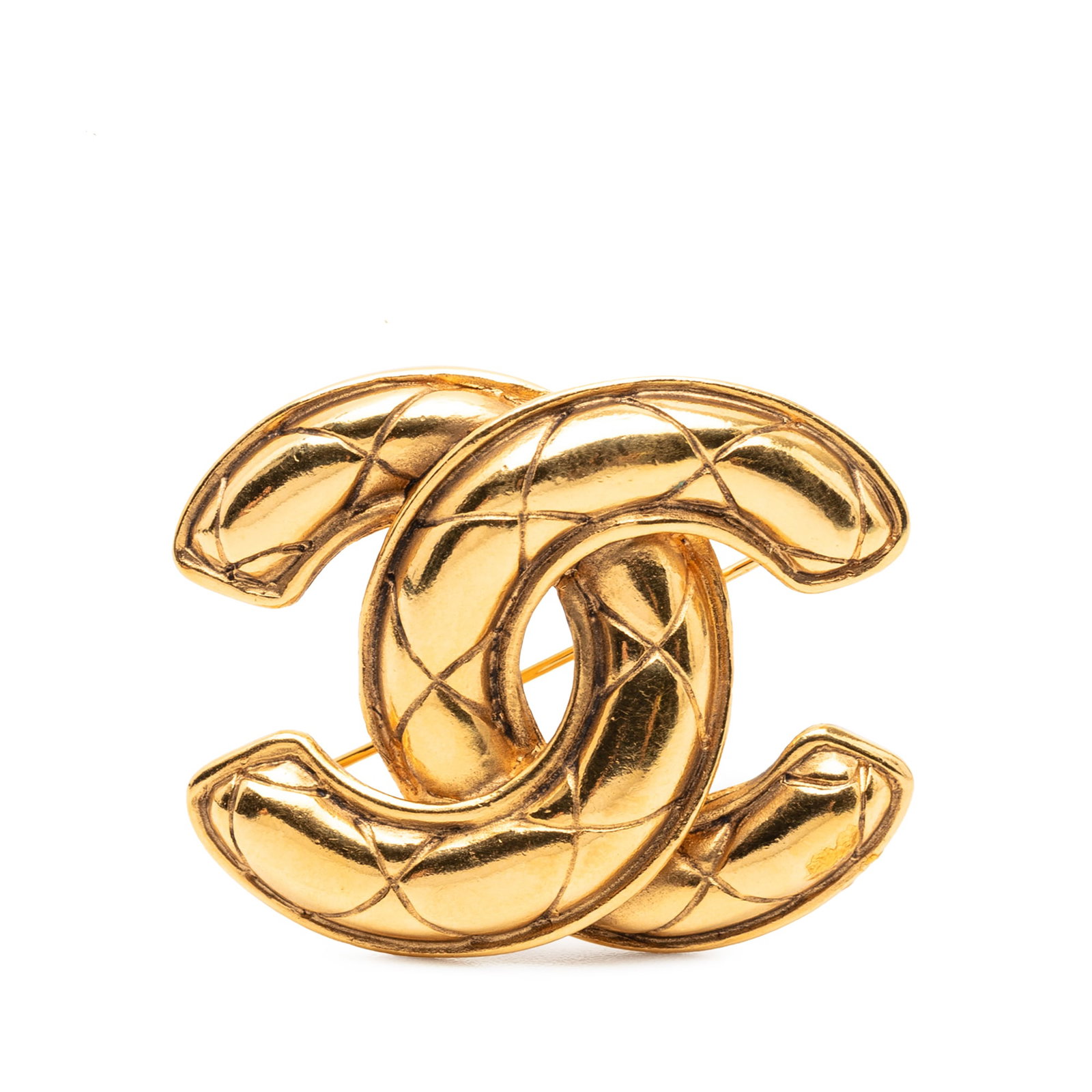 Chanel CC Gold Tone Quilted Pin Brooch: Chanel CC Gold Tone Quilted Pin Brooch This Chanel CC Gold Plated Quilted Brooch features a gold-tone metal body with a quilted design and a secure back pin closure. The brooch is crafted in France an