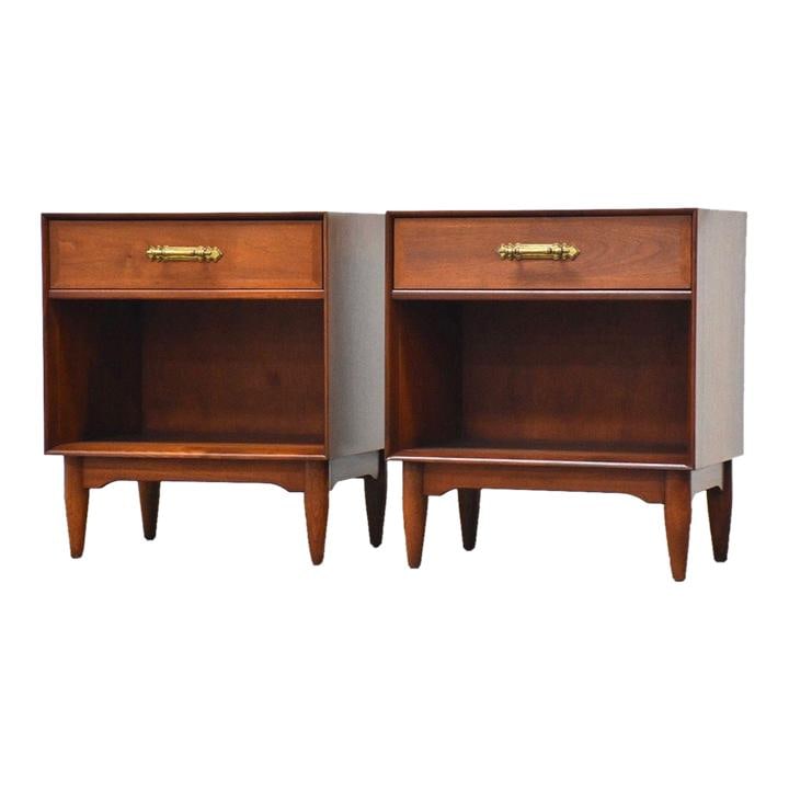 Elegant Pair of Ramseur Walnut Nightstands with Brass Pulls: Elegant Pair of Ramseur Walnut Nightstands with Brass Pulls This elegant pair of mid-century modern nightstands features a warm walnut finish and classic brass drawer pulls. Each nightstand includes a