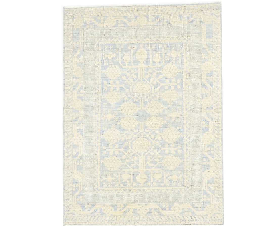 Hand-knotted wool Khotan area rug with floral pattern 4'1 x 5'8: Hand-knotted wool Khotan area rug with floral pattern 4'1 x 5'8 This handmade Khotan rug features a classic floral Oushak design with muted tones of blue, beige, and cream. Expertly hand-knotted from 