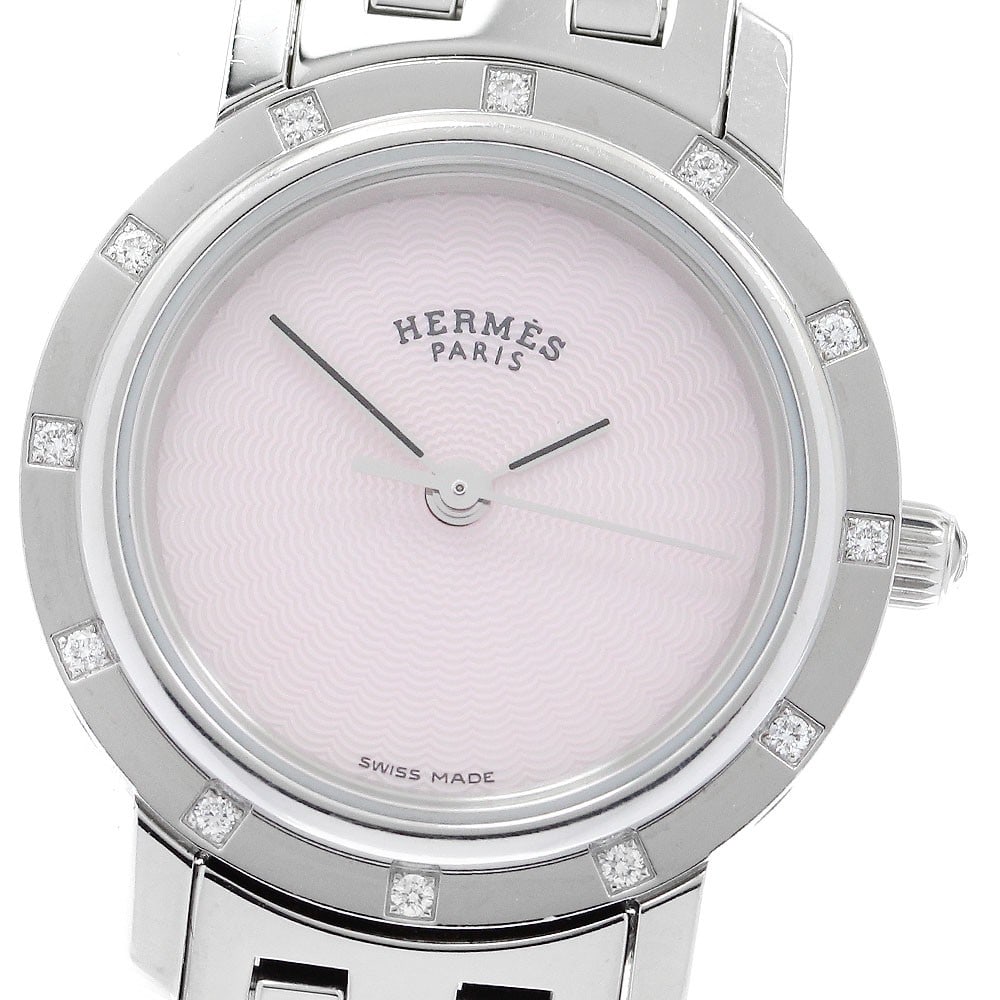 Hermes Clipper Nakule Diamond Quartz Ladies Watch CL4.230: Hermes Clipper Nakule Diamond Quartz Ladies Watch CL4.230 This pre-owned Hermes Clipper Nakule women's wristwatch features a stainless steel case and bracelet, complemented by a pink shell dial set wi