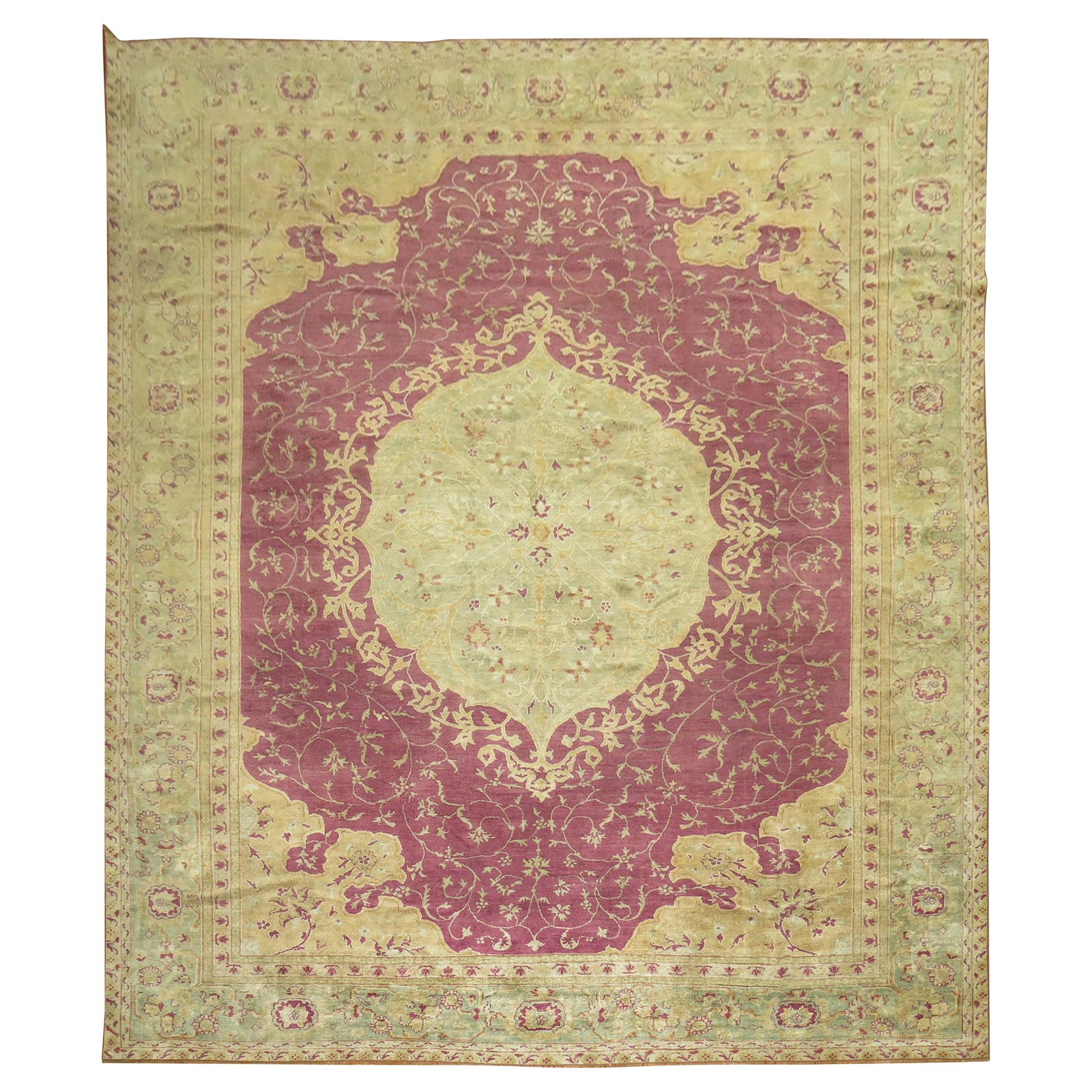 Early 20th Century Turkish Ghiordes Wool Oushak Rug: Early 20th Century Turkish Ghiordes Wool Oushak Rug This early 20th century Turkish Ghiordes rug features a plum-colored field with a mint green medallion and border accented in gold tones. Hand-woven