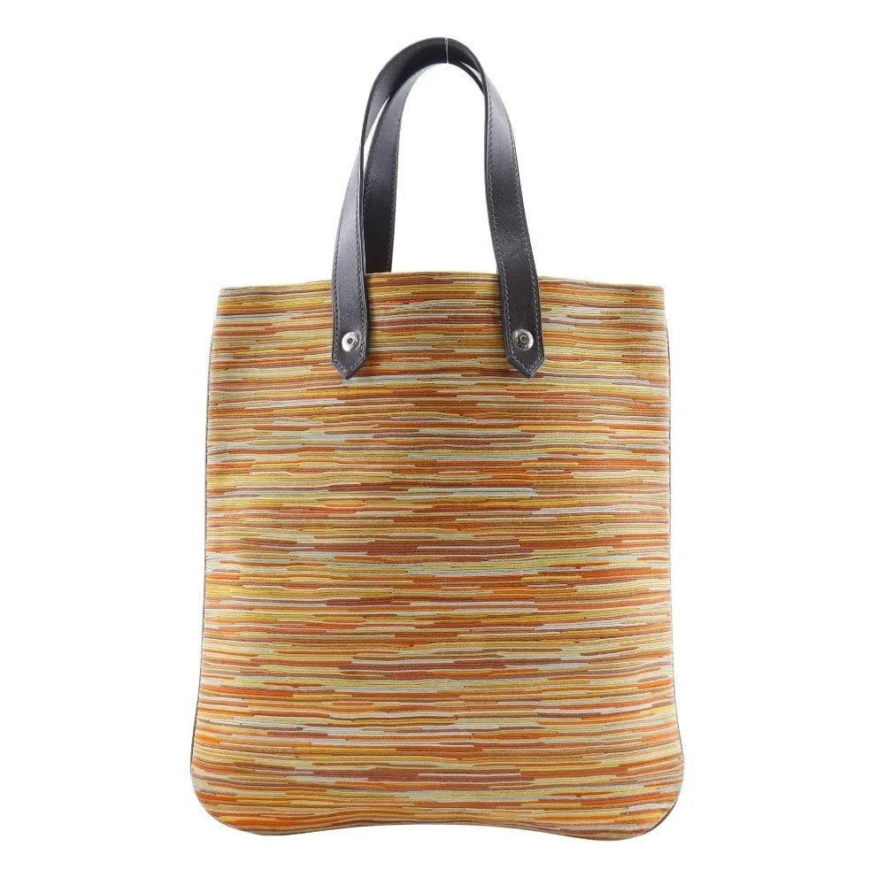 Canvas Hermes Ahmedabad Unisex Tote Bag Orange 25cm by 28cm: Canvas Hermes Ahmedabad Unisex Tote Bag Orange 25cm by 28cm The Hermes Ahmedabad Tote is a unisex handbag crafted from durable orange canvas. It features a compact design with dimensions of 25cm x 28c