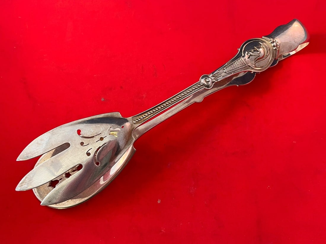 Victorian Wood & Hughes Medallion Warrior Sterling Silver Tongs 10 3/4": Victorian Wood & Hughes Medallion Warrior Sterling Silver Tongs 10 3/4" This exquisite sterling silver sandwich tong, measuring 10 3/4 inches, showcases the Medallion pattern, also known as Warrior, c