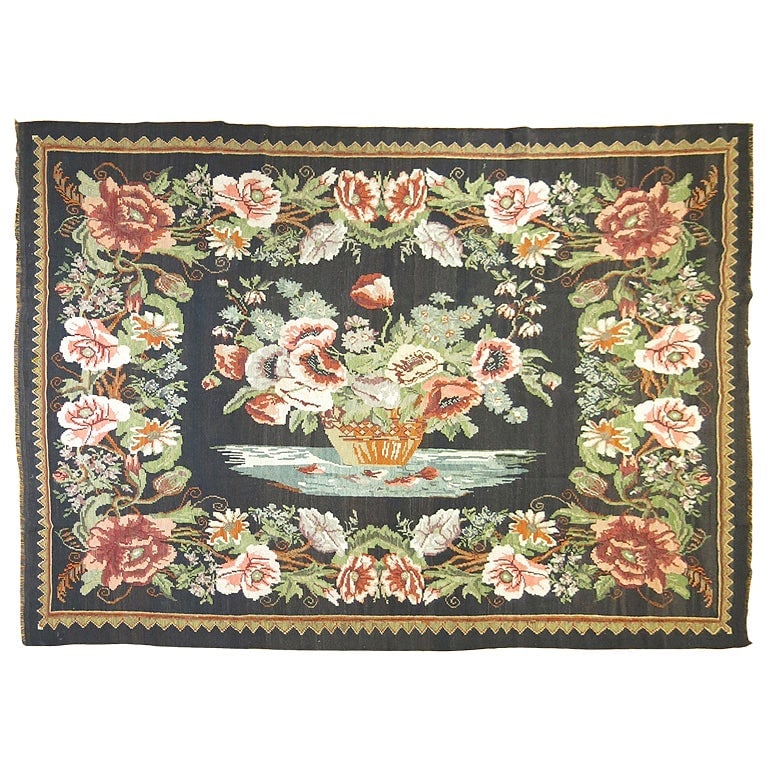 1940s Wool Hand Knotted Bessarabian Kilim Rug: 1940s Wool Hand Knotted Bessarabian Kilim Rug This handwoven Bessarabian Kilim from the 1940s features a romantic style and showcases a large flower vase motif. Crafted using traditional hand-knotted 