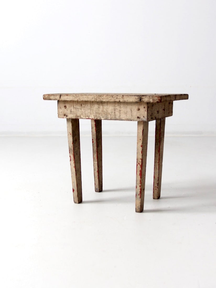 Antique Primitive Milking Stool Rustic Accent Furniture: Antique Primitive Milking Stool Rustic Accent Furniture This antique primitive milking stool showcases a rectangular wooden seat supported by splayed, tapered legs. The beautifully worn painted surfac