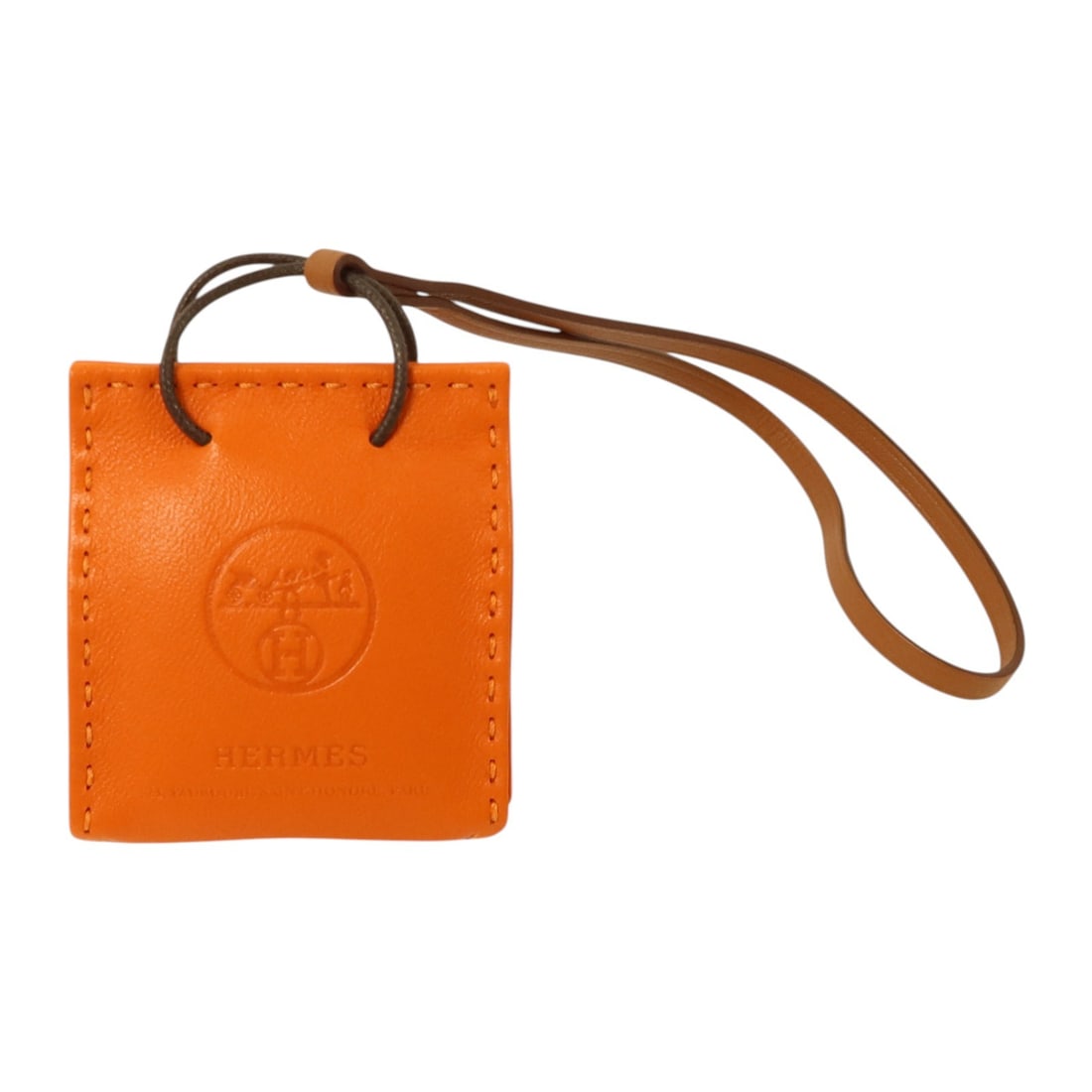Orange Lambskin Bag Charm by Hermes Milo Collection: Orange Lambskin Bag Charm by Hermes Milo Collection This Hermes Sac Orange bag charm is crafted from premium Milo lambskin leather in a vibrant orange hue. Designed for women, this accessory offers a 