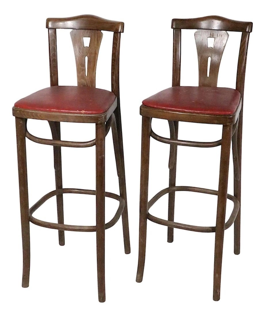Pair of Thonet bentwood counter stools with vinyl seats: Pair of Thonet bentwood counter stools with vinyl seats Pair of early to mid 20th century bentwood counter stools in a classic Vienna Secessionist style. They feature a pierce work slat back, bentwood