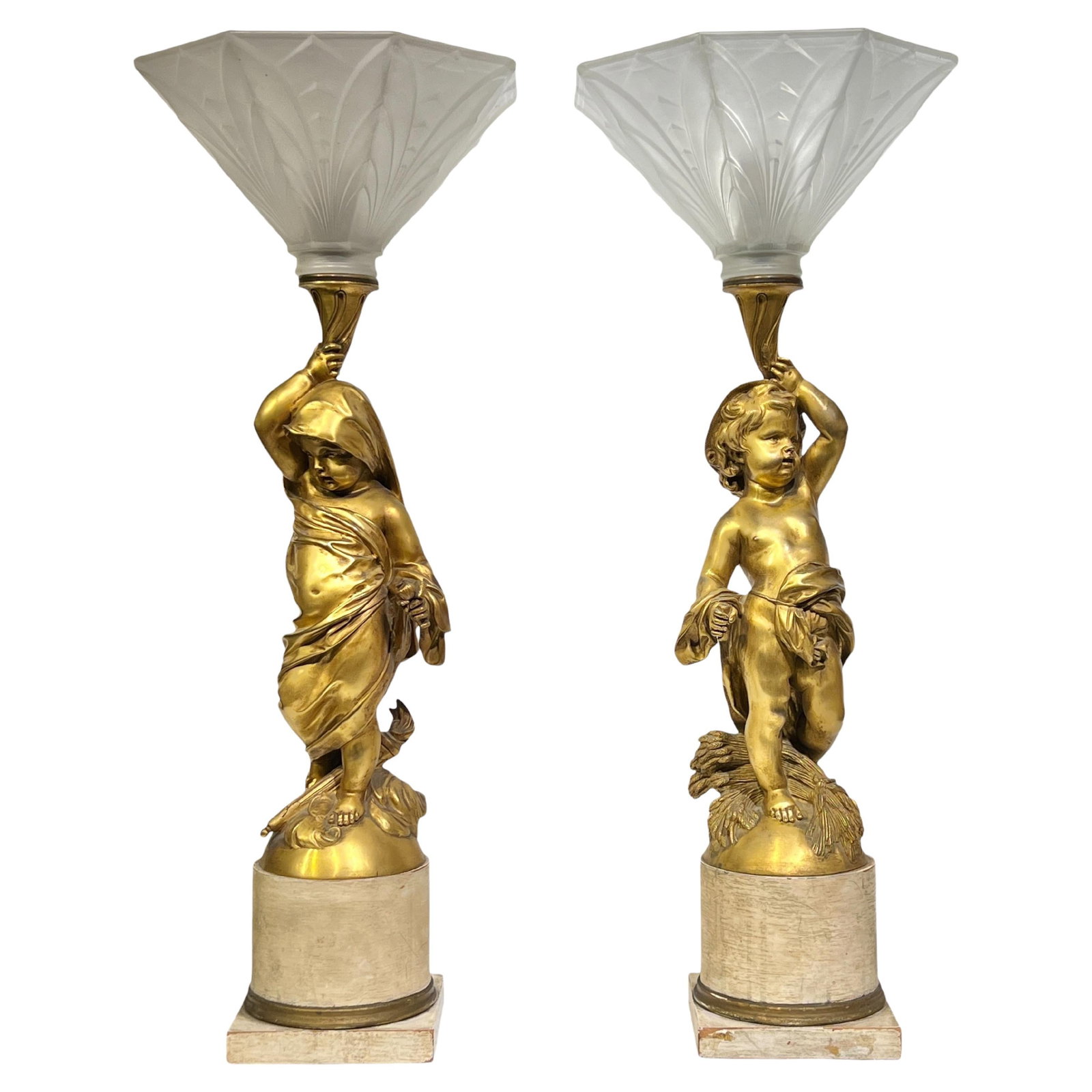 Set of Two Gilt Bronze Putti Table Lamps with Frosted Glass Shades: Set of Two Gilt Bronze Putti Table Lamps with Frosted Glass Shades This pair of neoclassical revival table lamps features antique gilt bronze figures of putti, each supporting an octagonal frosted gla