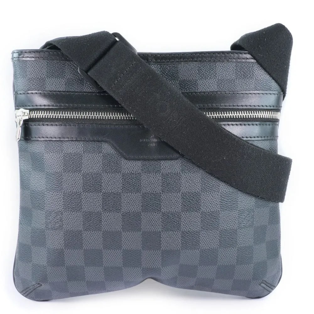 Louis Vuitton Thomas Unisex Canvas Bag in Black: Louis Vuitton Thomas Unisex Canvas Bag in Black The Louis Vuitton Thomas Handbag in Damier Graphite canvas is a unisex accessory featuring a sleek black color. Crafted in France, it measures 25cm x 23