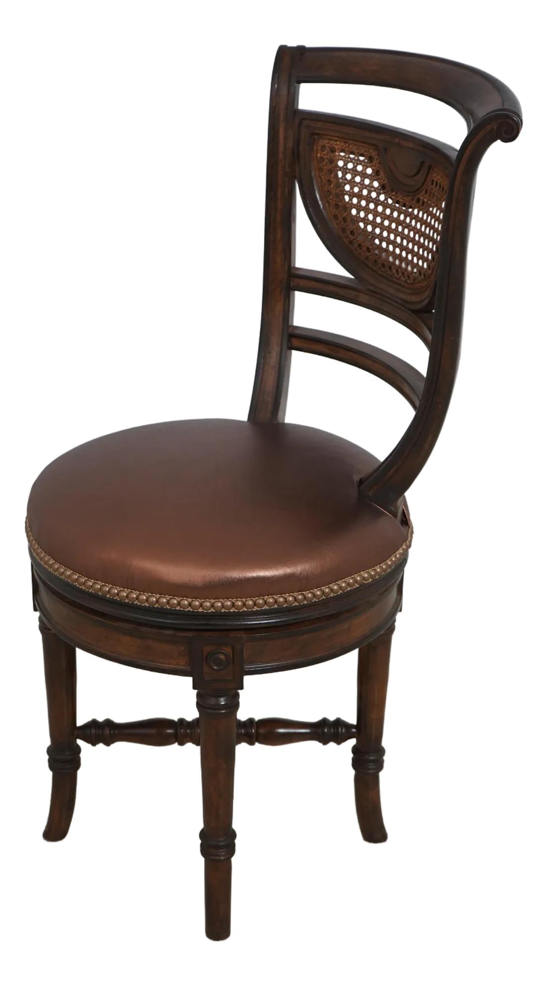 Regency Style Revolving Stool Walnut Finish Faux Leather Seat: Regency Style Revolving Stool Walnut Finish Faux Leather Seat This exquisite Regency Style Revolving Seat Piano or Vanity Stool features a stunning walnut finish and has been newly upholstered in a ri