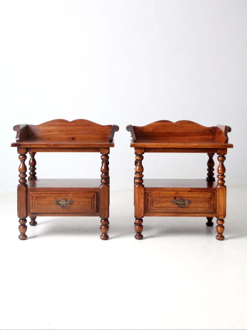 Pair of Mid-Century Colonial Revival Wood End Tables with Turned Legs: Pair of Mid-Century Colonial Revival Wood End Tables with Turned Legs This pair of mid-20th century vintage Colonial Revival end tables features turned legs, paneled drawers, and gently shaped gallery