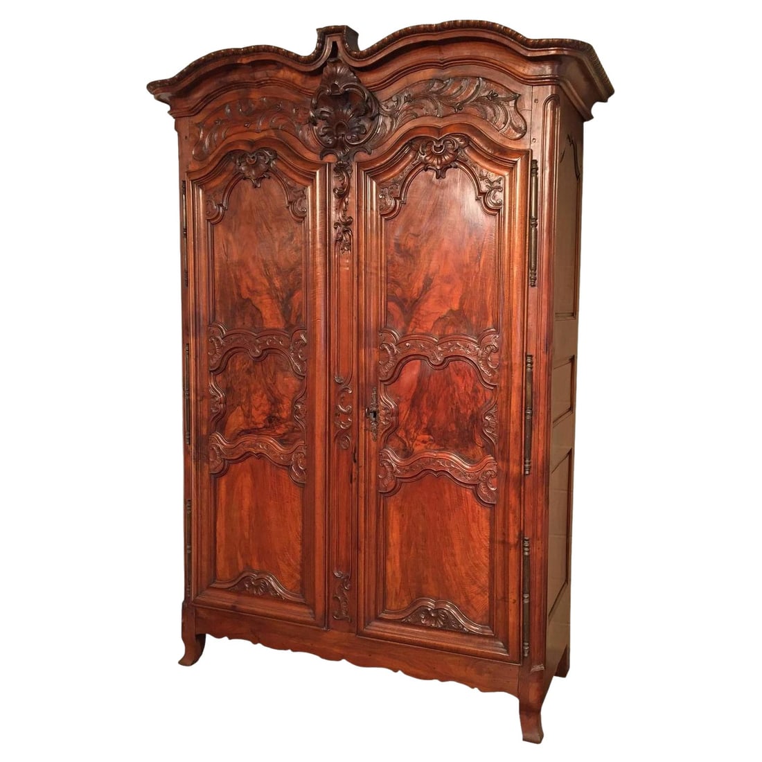 French Louis XV Walnut Armoire Lyonnaise with Ornate Carved Double Doors circa 1760: French Louis XV Walnut Armoire Lyonnaise with Ornate Carved Double Doors circa 1760 This impressive mid-18th century French Louis XV armoire, crafted in Lyon around 1760, showcases exquisite hand-carv