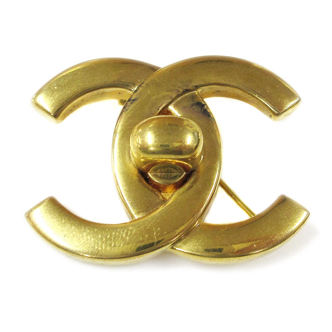 Chanel CC Logo Turnlock Brooch Pin Gold Tone 96P: Chanel CC Logo Turnlock Brooch Pin Gold Tone 96P Large Chanel turnlock brooch pin featuring the iconic CC logo motif in a gold-tone finish. Made in France, this piece is marked 96P and shows reasonabl