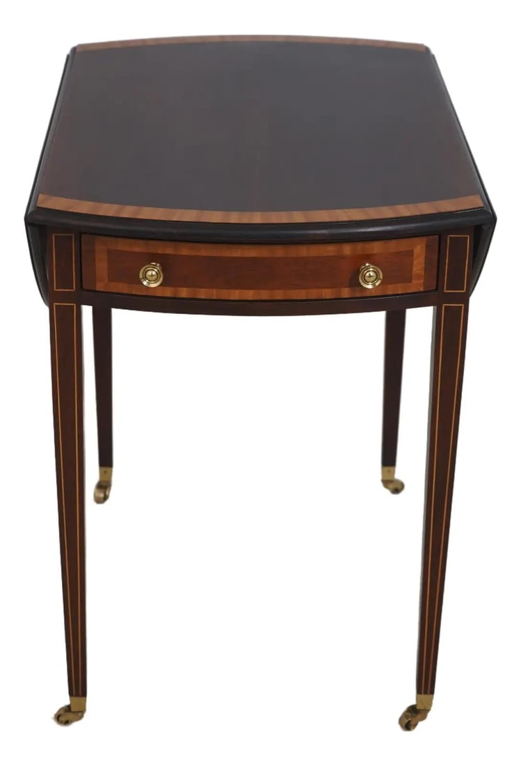 Federal Style Mahogany Pembroke Table with Drop Leaves and Brass Accents: Federal Style Mahogany Pembroke Table with Drop Leaves and Brass Accents This Federal style Pembroke table features a mahogany construction with a rich, high sheen finish. The table showcases elegant 