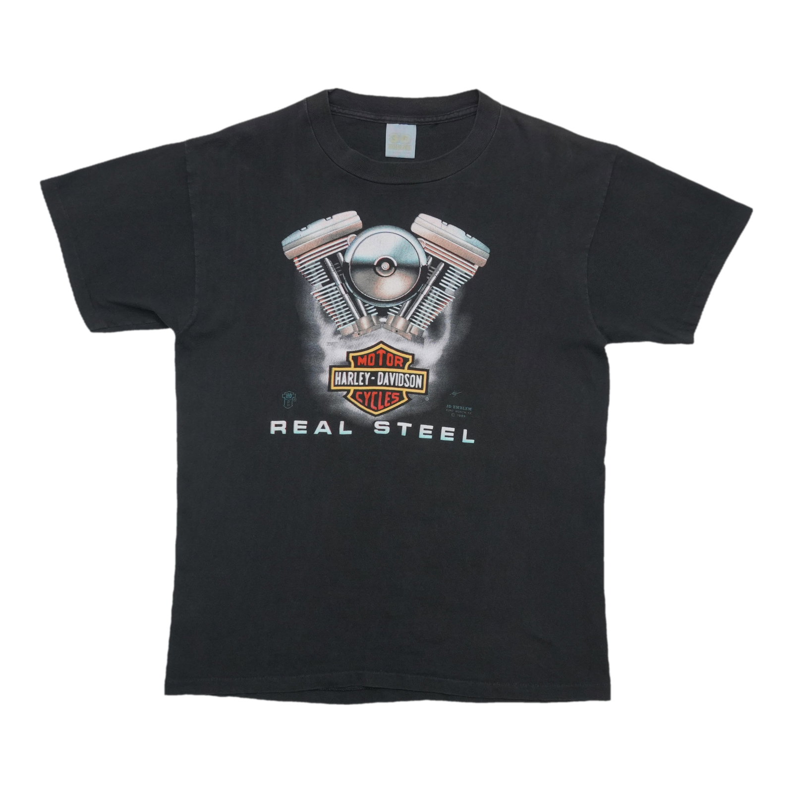1989 Harley Davidson black cotton tee with 3D steel emblem: 1989 Harley Davidson black cotton tee with 3D steel emblem This is an original vintage 1989 Harley Davidson Real Steel 3D Emblem shirt featuring front and back graphics. Made from 100% cotton, this bl