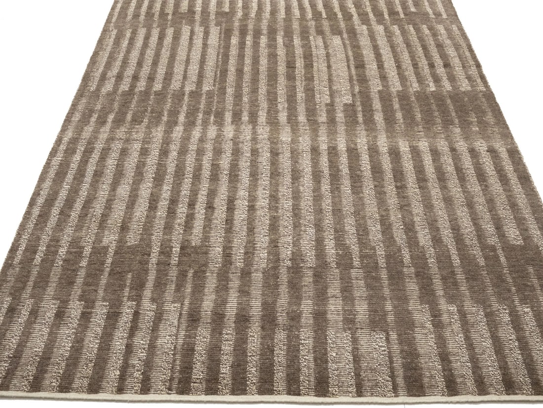 Modern Abstract Wool Hand-Knotted Area Rug 8x10 Brown Bas-Relief Design: Modern Abstract Wool Hand-Knotted Area Rug 8x10 Brown Bas-Relief Design This 8x10 modern Oriental rug features a hand-knotted bas-relief design in brown and cream tones. Made of wool, it showcases an 