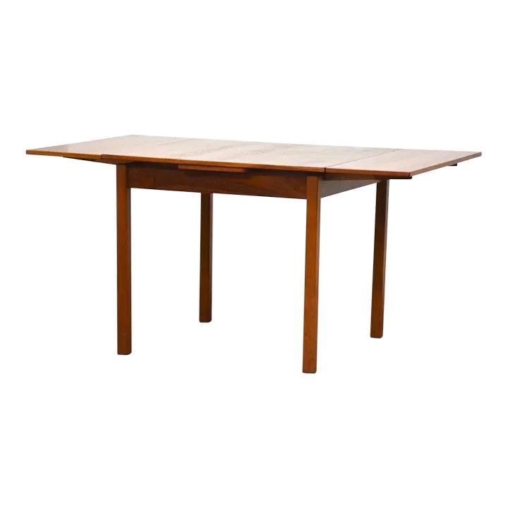 1960s Danish Modern Teak Square Dining Table with Extensions: 1960s Danish Modern Teak Square Dining Table with Extensions This elegant 1960s Danish Modern square dining table features a beautifully crafted teak wood construction, offering a warm brown finish th