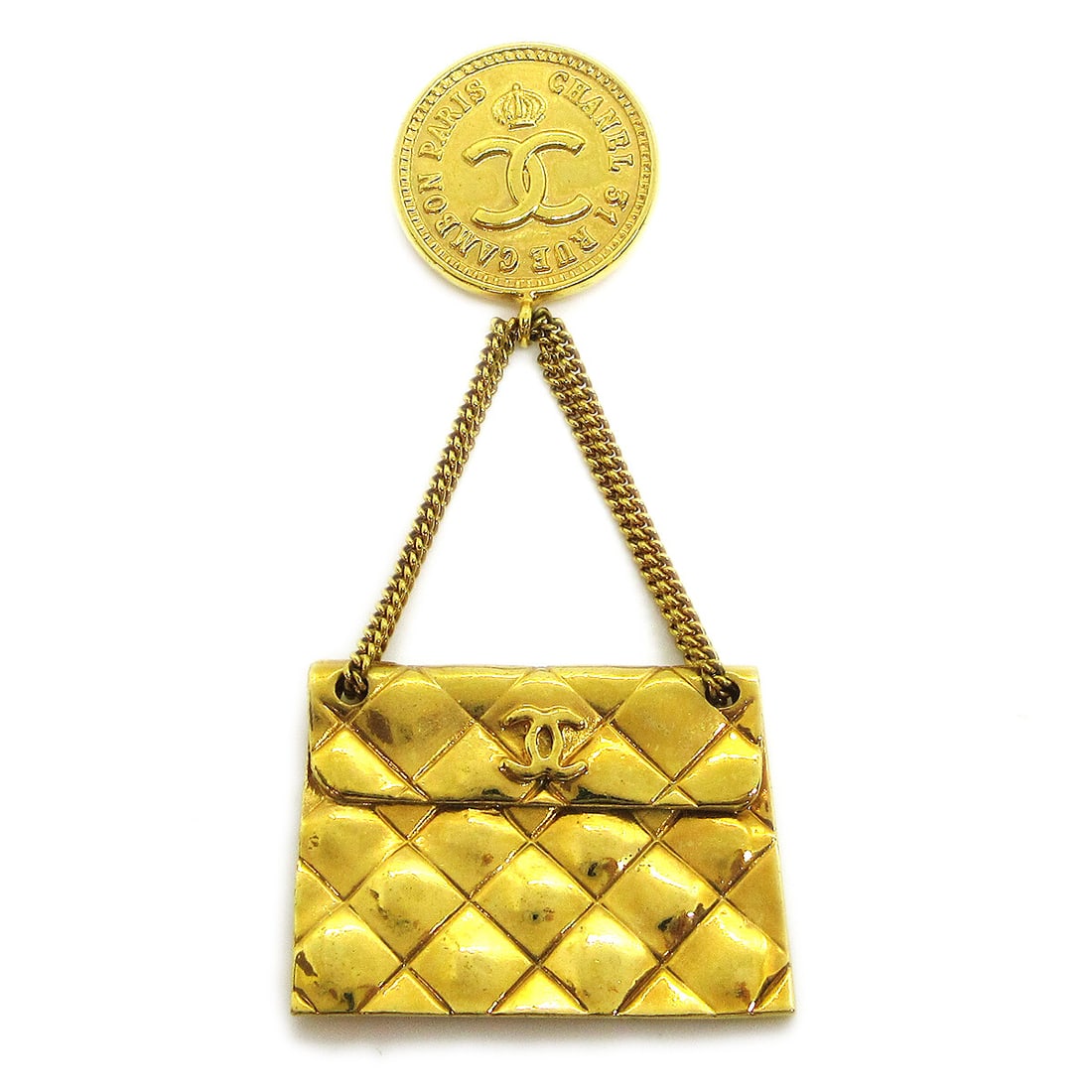 Chanel 93P Gold Tone Quilted Bag Motif Brooch Pin: Chanel 93P Gold Tone Quilted Bag Motif Brooch Pin Gold-tone Chanel brooch pin featuring a quilted bag motif with a coin charm. Made in France, this piece is styled in the form of a handbag and shows r
