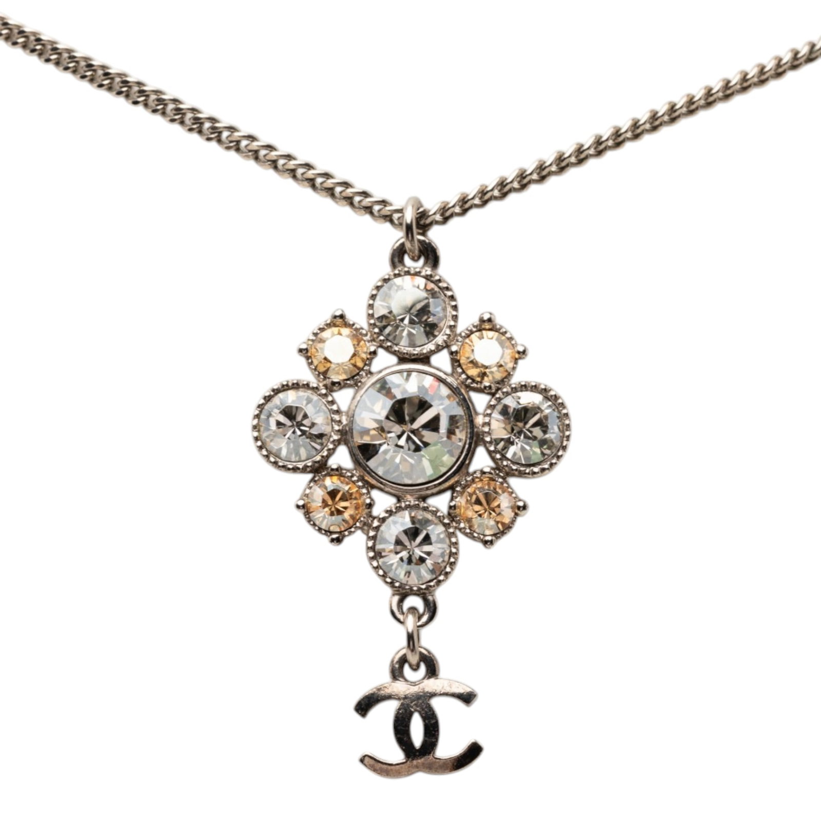 Chanel silver plated crystal pendant necklace: Chanel silver plated crystal pendant necklace This Chanel necklace features a silver plated chain and pendant adorned with crystal details. The design includes a lobster clasp closure for secure wear.