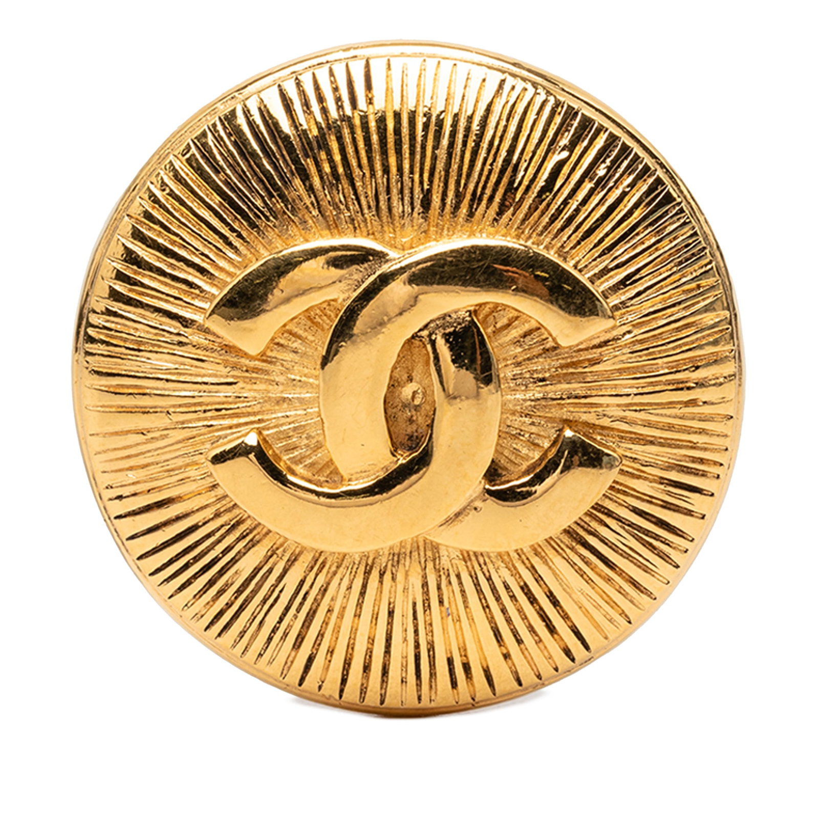 Chanel CC Sunburst Round Gold Plated Brooch: Chanel CC Sunburst Round Gold Plated Brooch Round sunburst brooch by Chanel with the iconic CC motif. It is crafted in gold plated metal and secures with a back pin closure. Condition is AB with visib