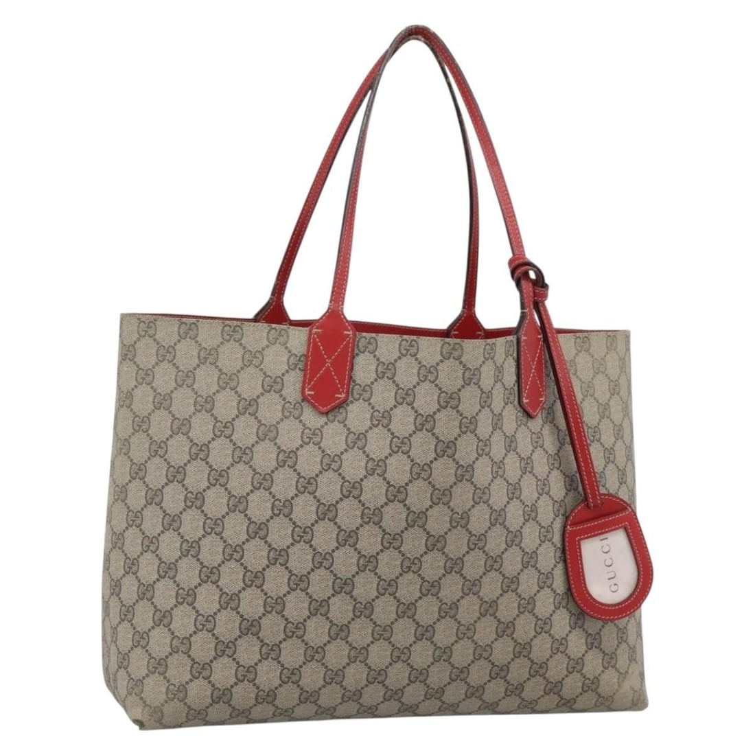 GUCCI Reversible PVC Leather Tote in Red Beige with Name Tag: GUCCI Reversible PVC Leather Tote in Red Beige with Name Tag Authentic Gucci GG Supreme reversible tote bag in red and beige PVC leather with GG canvas. This women's tote includes a name tag and was m