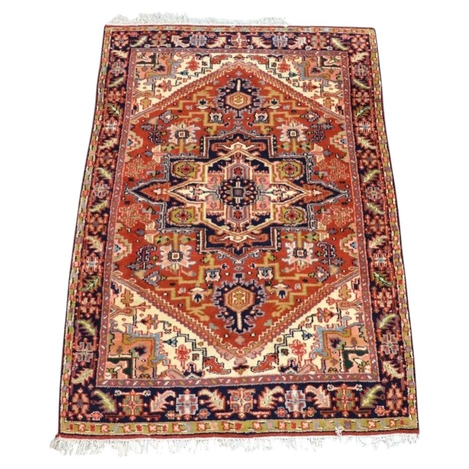 54 in x 77.75 in Persian Heriz hand-knotted wool rug c1930: 54 in x 77.75 in Persian Heriz hand-knotted wool rug c1930 Antique Heriz Persian oriental wool rug dating to circa 1930, hand-knotted in Persia. It features a classic medallion design with a prominent