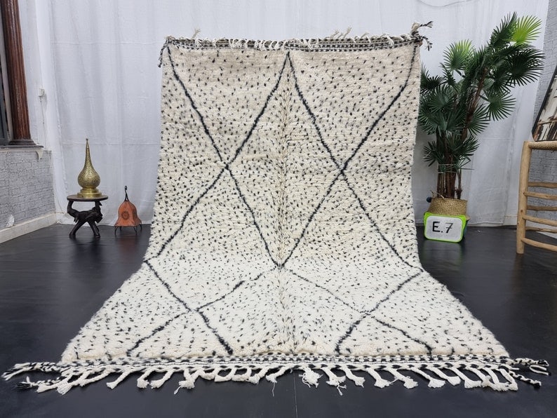 Authentic Moroccan Berber Wool Rug 8 x 5 Feet: Authentic Moroccan Berber Wool Rug 8 x 5 Feet Enhance your space with this stunning authentic dotted soft white Moroccan Berber wool rug. Handwoven in the Atlas Mountains by skilled Berber women weave