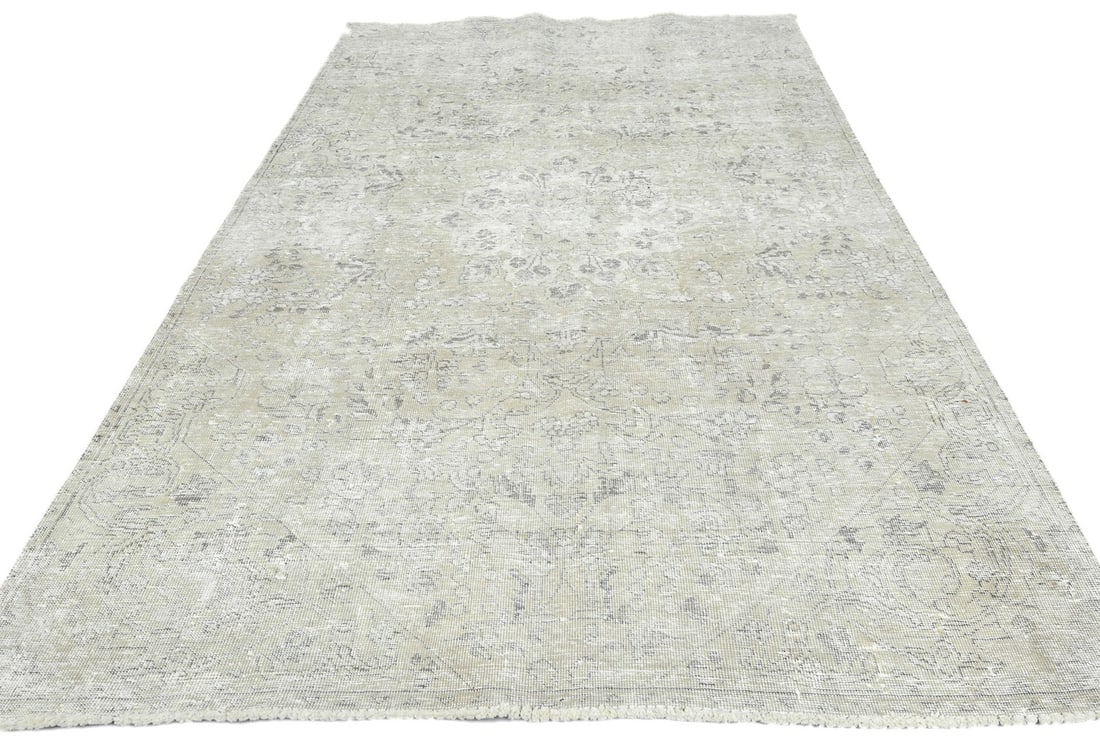 5'2 x 8'2 Hand-Knotted Wool Vintage Floral Area Rug Western Asia: 5'2 x 8'2 Hand-Knotted Wool Vintage Floral Area Rug Western Asia This handmade antique distressed Oriental rug features a muted floral design in beige, cream, dark brown, and other soft tones. Crafted
