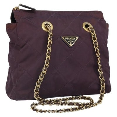 Prada Nylon Shoulder Bag Purple with Gold Tone Chain Quilting: Prada Nylon Shoulder Bag Purple with Gold Tone Chain Quilting Prada chain quilted shoulder bag in purple nylon with gold-tone accents. Made in Italy, this shoulder bag is offered in heavily used condi