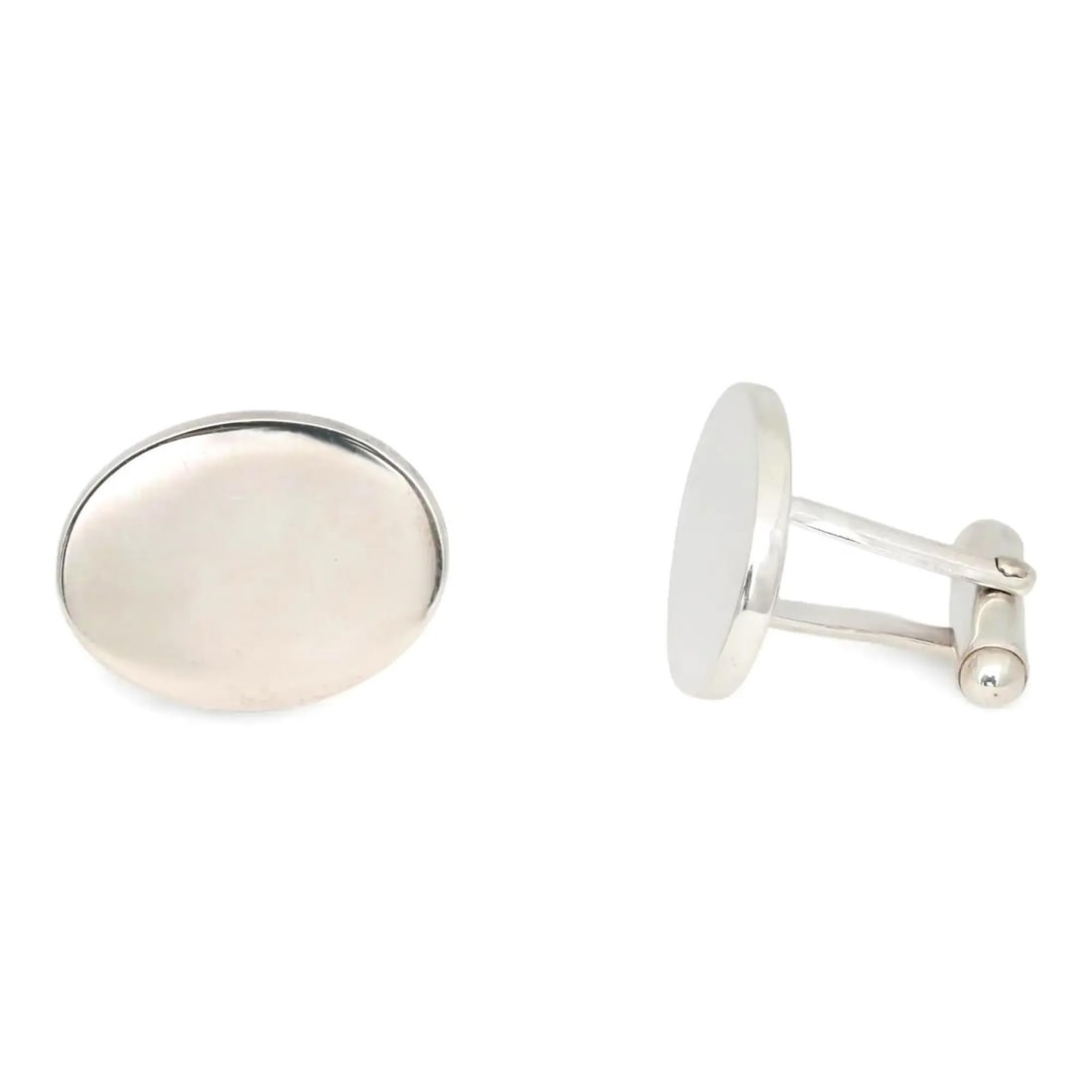 Tiffany & Co. Classic Oval Cufflinks in 925 Sterling Silver: Tiffany & Co. Classic Oval Cufflinks in 925 Sterling Silver Elevate your formal attire with these classic oval cufflinks from Tiffany & Co. Crafted from 925 sterling silver, these cufflinks feature a 