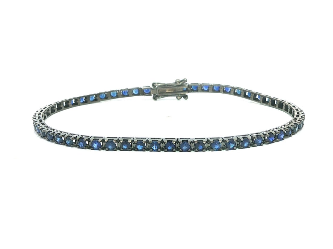Blue Sapphire Tennis Bracelet 18k White Gold Black Rhodium 2.6ctw 6.5 Inch: Blue Sapphire Tennis Bracelet 18k White Gold Black Rhodium 2.6ctw 6.5 Inch This un-used tennis bracelet features 57 natural round brilliant cut blue sapphires with a total carat weight of 2.6ct, set i
