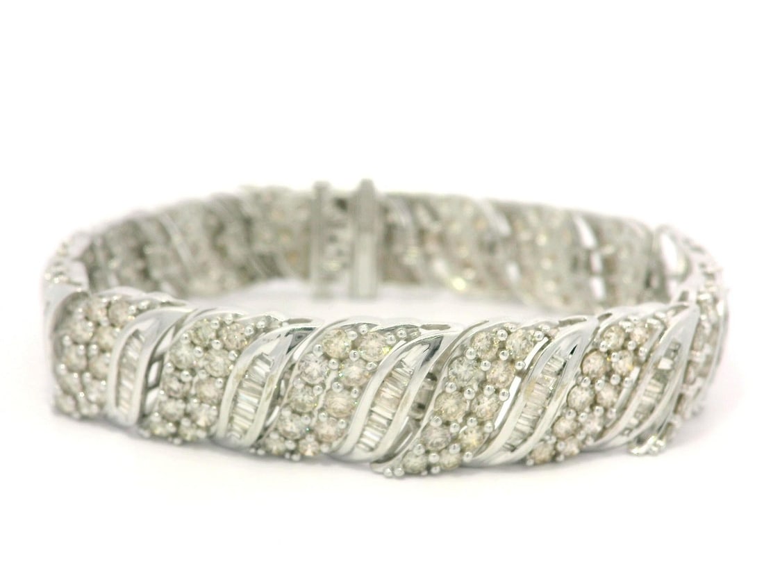 10k White Gold 7ctw Champagne Diamond Tennis Bracelet 12.3mm Wide: 10k White Gold 7ctw Champagne Diamond Tennis Bracelet 12.3mm Wide This stunning tennis bracelet features a captivating combination of fiery baguette and round diamonds, elegantly set in 10k solid whit