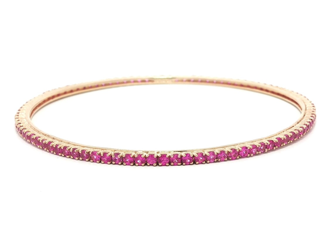 18K Rose Gold Tennis Bangle Bracelet with Vivid Pink Sapphires: 18K Rose Gold Tennis Bangle Bracelet with Vivid Pink Sapphires This exquisite tennis bangle bracelet features a stunning array of natural, round brilliant-cut pink sapphires, each approximately 2mm in