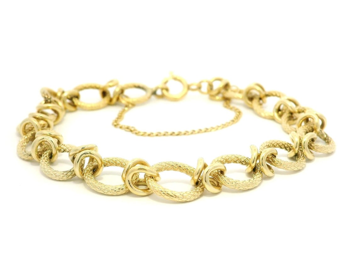 Vintage 14k Yellow Gold Snake Skin Texture Link Bracelet 7.0 in: Vintage 14k Yellow Gold Snake Skin Texture Link Bracelet 7.0 in This exquisite vintage bracelet features a unique open oval snake skin texture paired with spiral station links, crafted from solid yell