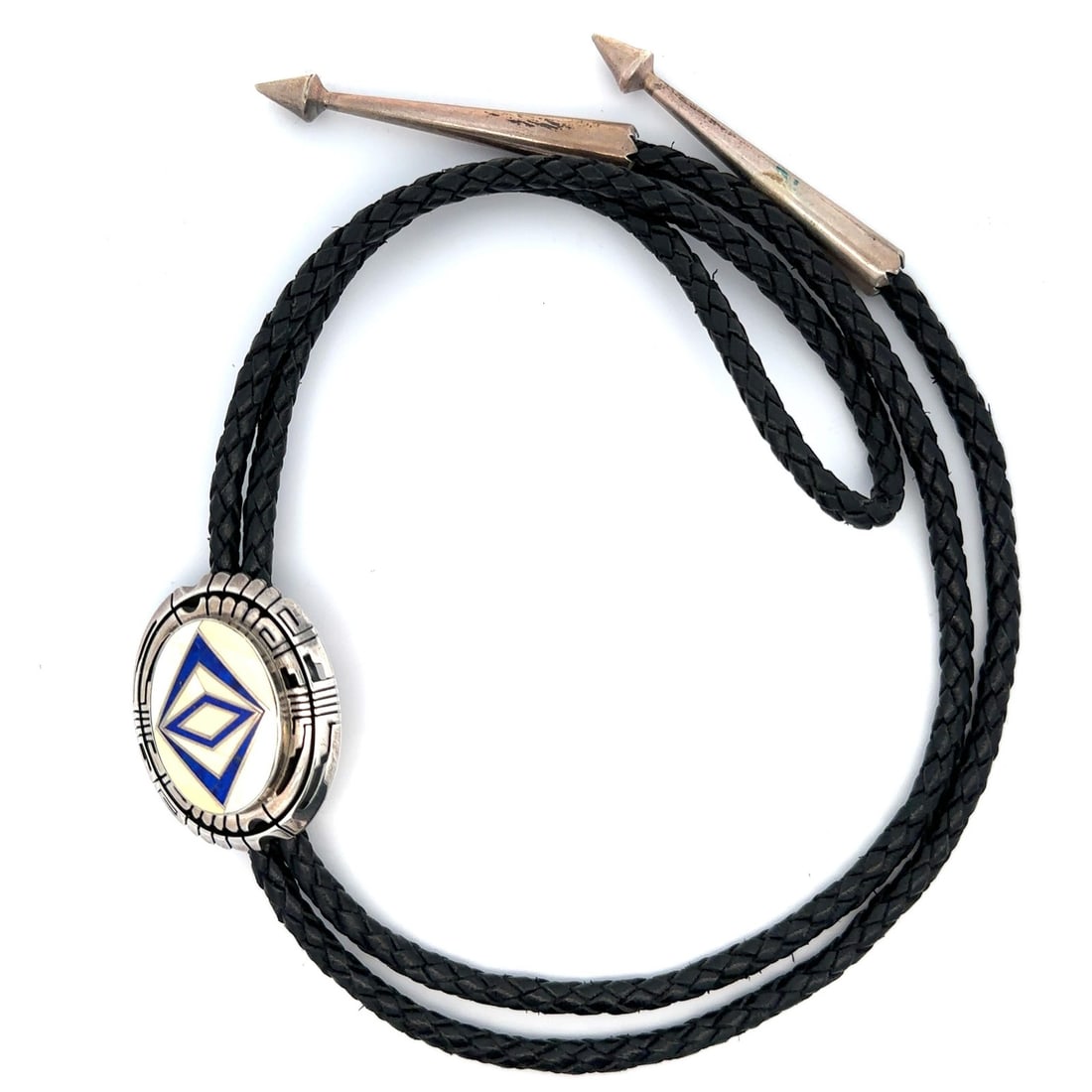 Sterling Silver Leather Bolo Tie With Lapis Lazuli and White Stone Inlay: Sterling Silver Leather Bolo Tie With Lapis Lazuli and White Stone Inlay This bolo tie features a custom design by Gilbert Nelson, crafted in sterling silver with inlay and bezel settings. The centerp