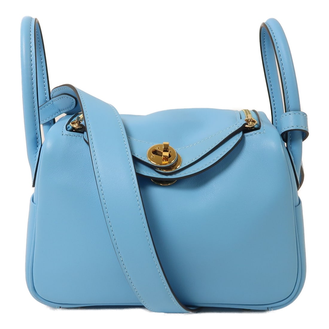 Hermes Mini Lindy Blue Calfskin 2 Way Shoulder Bag GHW: Hermes Mini Lindy Blue Calfskin 2 Way Shoulder Bag GHW This Hermes Mini Lindy 2-way shoulder bag is crafted from Veau Swift calfskin leather in a striking blue shade. Featuring gold-tone hardware, it 