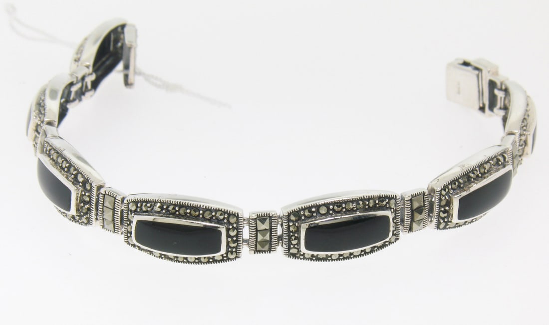 Sterling Silver Onyx Marcasite Tennis Bracelet 7in Hook Clasp: Sterling Silver Onyx Marcasite Tennis Bracelet 7in Hook Clasp This elegant tennis bracelet features flush-set black onyx stones with polished sterling silver borders, each stone in a rounded