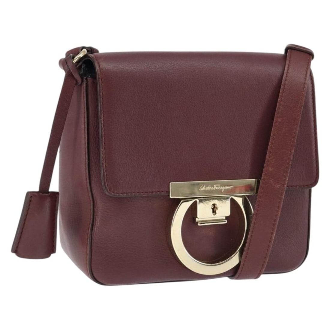 Salvatore Ferragamo Gancini Bordeaux Leather Shoulder Bag with Gold Accents: Salvatore Ferragamo Gancini Bordeaux Leather Shoulder Bag with Gold Accents This authentic Salvatore Ferragamo Gancini Shoulder Bag is a stylish and functional accessory crafted from high-quality leat