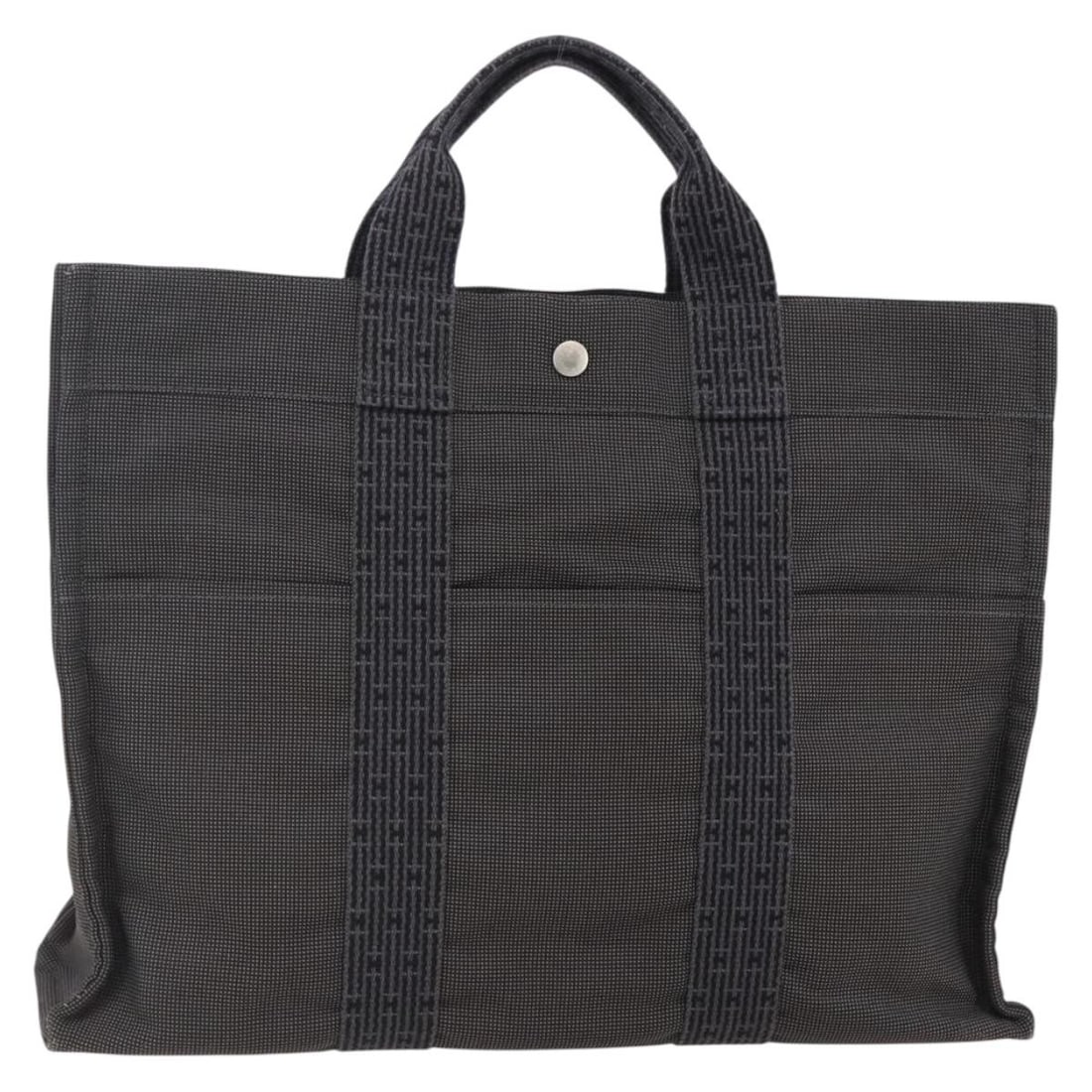 HERMES Her Line MM Hand Bag Gray Canvas Made in France: HERMES Her Line MM Hand Bag Gray Canvas Made in France Introducing the HERMES Her Line MM Hand Bag, an elegant accessory crafted in France. This stylish hand bag features a durable gray canvas exterio