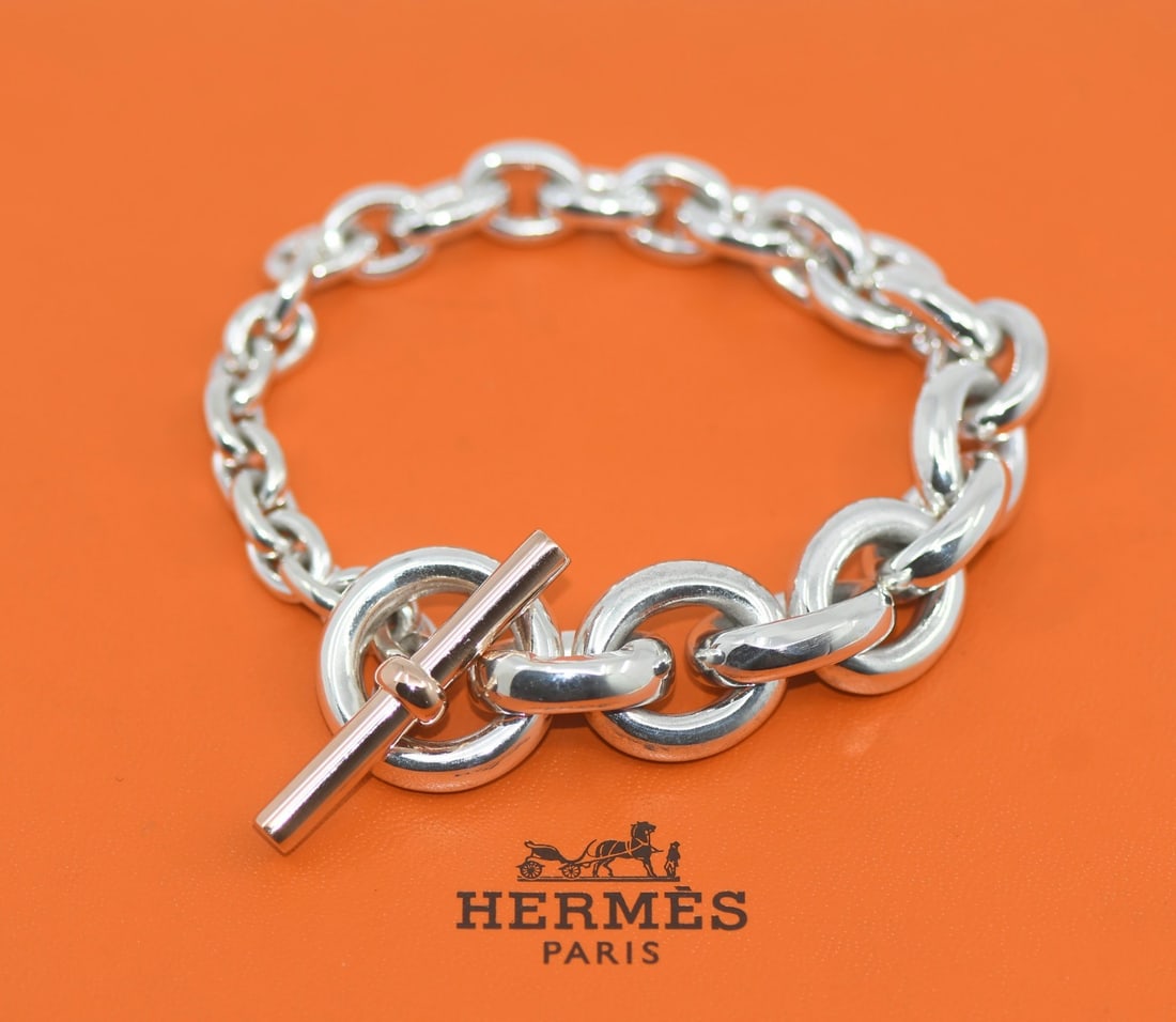 Crescendo Patine Sterling Silver Chain Bracelet by Hermes with Box: Crescendo Patine Sterling Silver Chain Bracelet by Hermes with Box This Hermes Crescendo Patine bracelet features a chain style crafted from 925 sterling silver. The bracelet does not include a main s