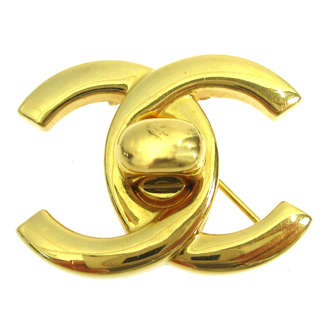 CHANEL 96A Gold Plated Turnlock CC Logo Brooch: CHANEL 96A Gold Plated Turnlock CC Logo Brooch Small Chanel brooch pin featuring the CC logo with a turnlock motif in gold-plated metal. Made in France. Condition noted as very good. Specifications Br